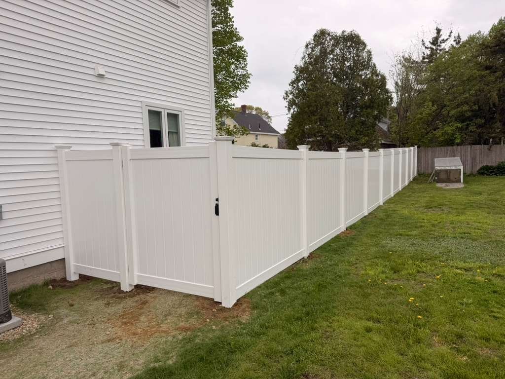 White vinyl privacy fence with walk gate