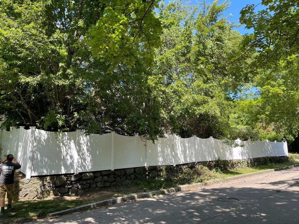 White vinyl privacy fence, New England suburb