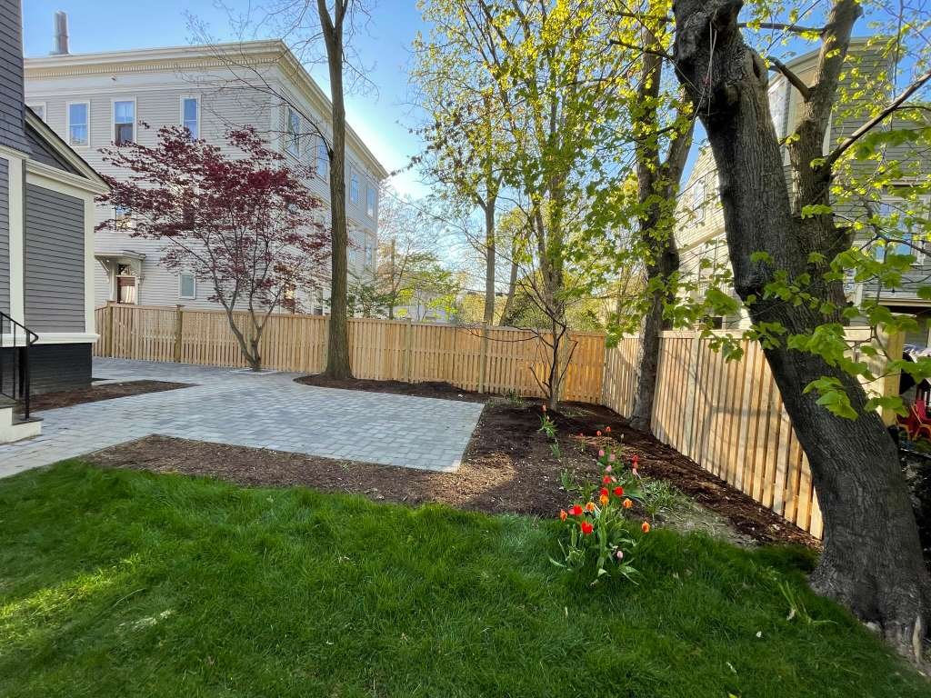 Cedar wood fence alongside backyard patio