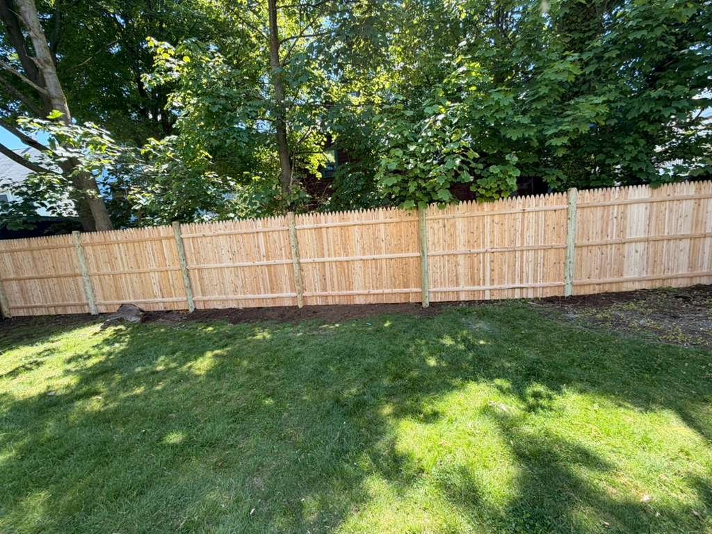 Long straight wood privacy fence installation
